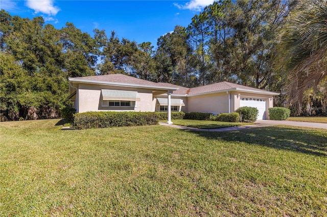 single story home featuring a garage and a front lawn