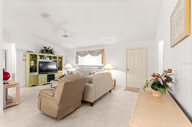 living room featuring ceiling fan, light tile patterned floors, and lofted ceiling