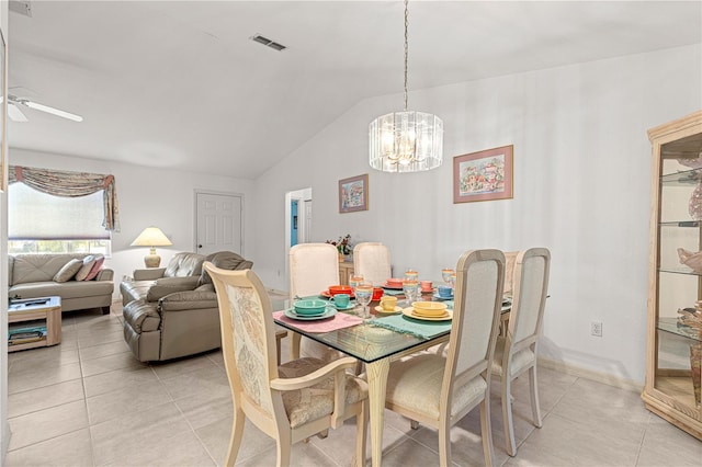 tiled dining room featuring ceiling fan with notable chandelier and lofted ceiling