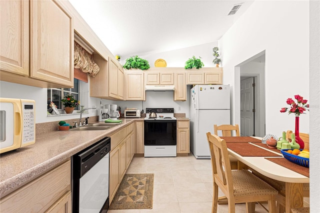 kitchen featuring white appliances, sink, vaulted ceiling, light tile patterned floors, and light brown cabinetry