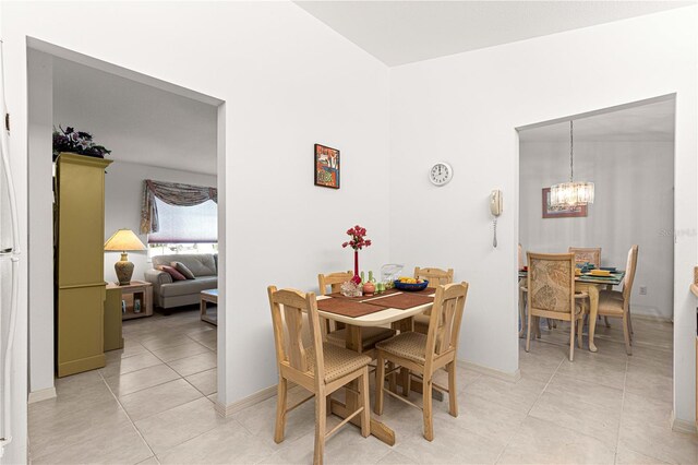 tiled dining area featuring a chandelier