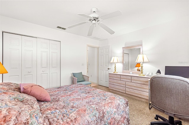 carpeted bedroom featuring ceiling fan and a closet