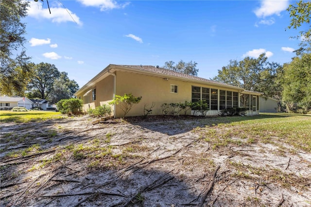 back of property featuring a sunroom