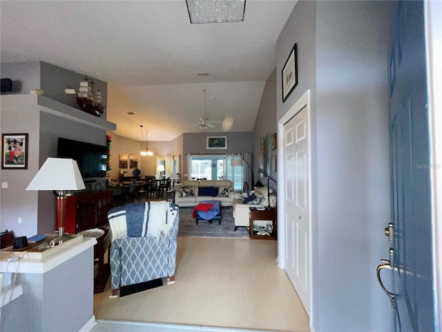 living room with ceiling fan, hardwood / wood-style floors, and lofted ceiling