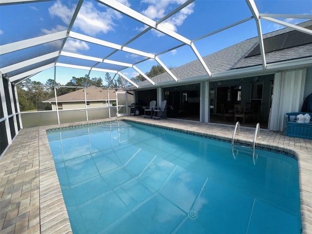 view of swimming pool with glass enclosure and a patio area