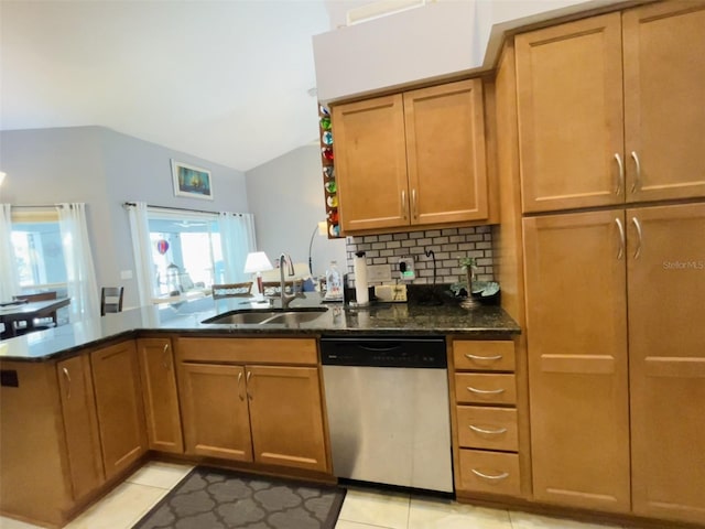 kitchen with dishwasher, sink, kitchen peninsula, dark stone countertops, and lofted ceiling