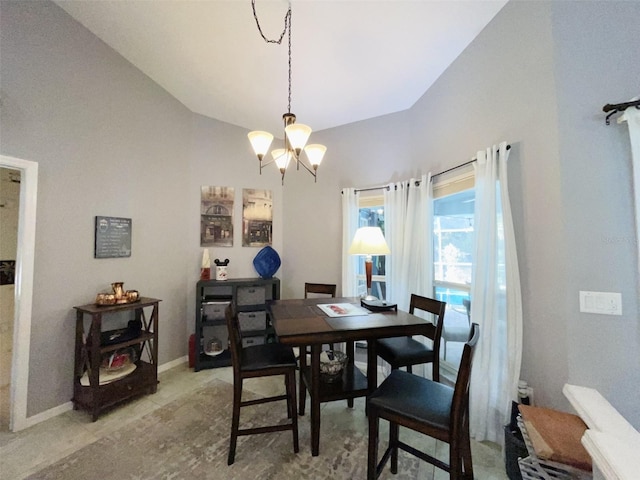 dining space featuring lofted ceiling and a chandelier