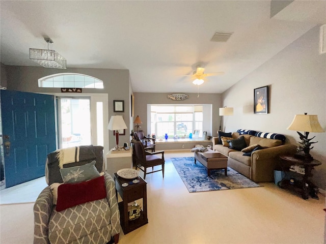 carpeted living room featuring ceiling fan and lofted ceiling