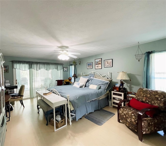 bedroom with a textured ceiling and ceiling fan