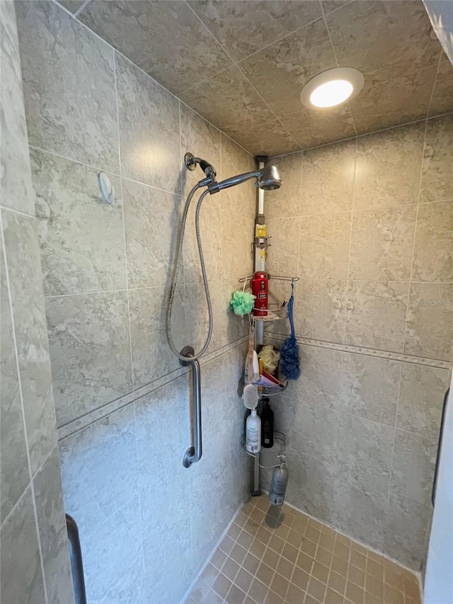 bathroom featuring a tile shower and tile patterned floors