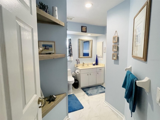 bathroom featuring vanity and toilet