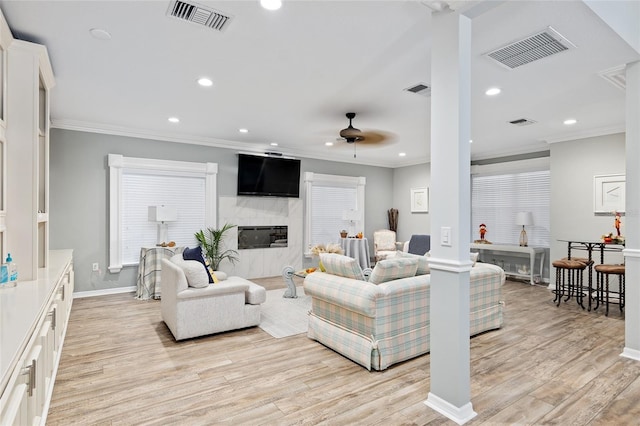 living room featuring ceiling fan, light hardwood / wood-style floors, and ornamental molding