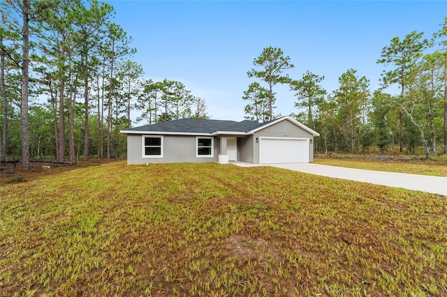 ranch-style home featuring a garage and a front lawn