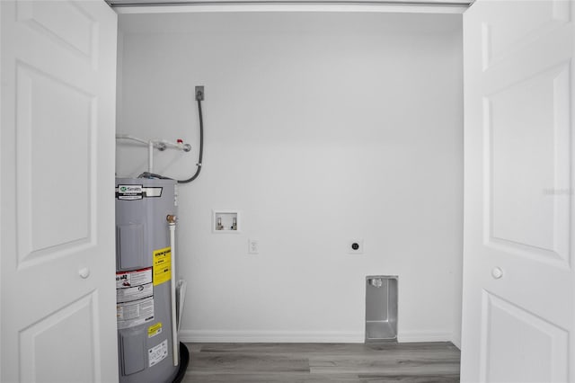 washroom featuring electric dryer hookup, hookup for a washing machine, water heater, and light hardwood / wood-style flooring