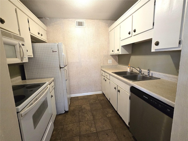 kitchen featuring a textured ceiling, white appliances, white cabinetry, and sink