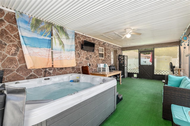 miscellaneous room featuring ceiling fan, dark carpet, and a hot tub