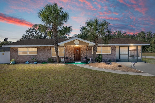 ranch-style house with a lawn