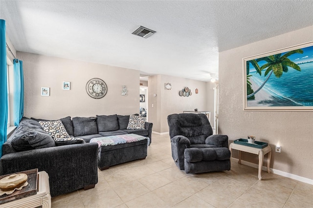 living room with light tile patterned floors and a textured ceiling