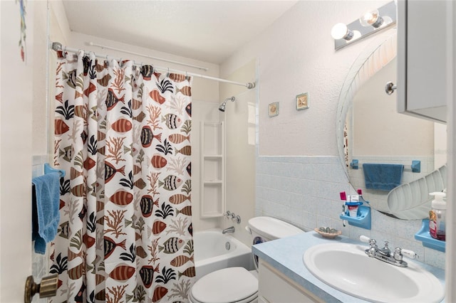 full bathroom with vanity, toilet, shower / bath combo with shower curtain, and tile walls