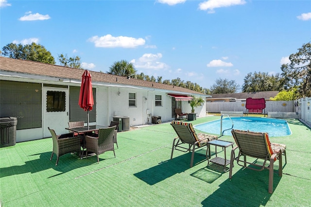 view of pool featuring pool water feature and central AC