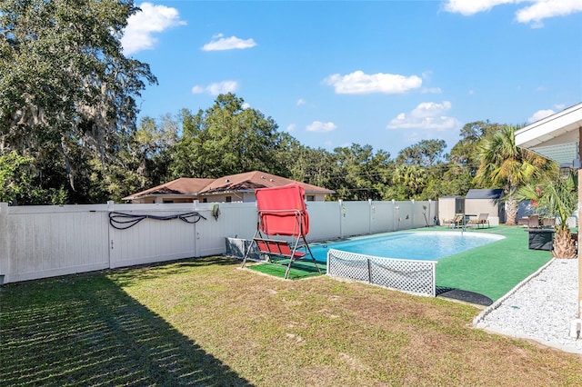 view of pool featuring a lawn