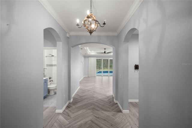 hall featuring a chandelier, crown molding, and light parquet floors