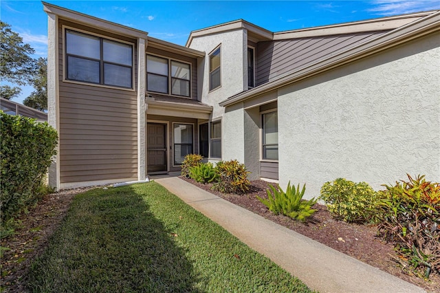 property entrance with a yard