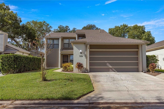 view of front of home featuring a front yard and a garage