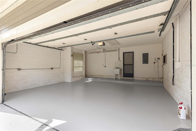 garage featuring electric panel and a garage door opener