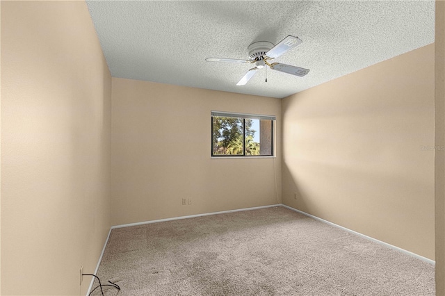 carpeted empty room featuring ceiling fan and a textured ceiling