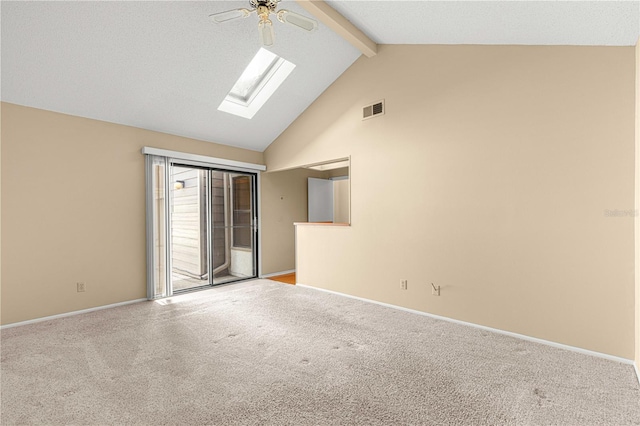 carpeted spare room with beamed ceiling, a skylight, high vaulted ceiling, and ceiling fan