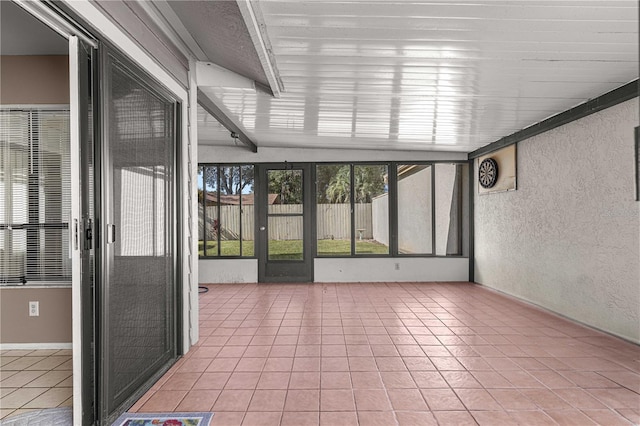 unfurnished sunroom with vaulted ceiling