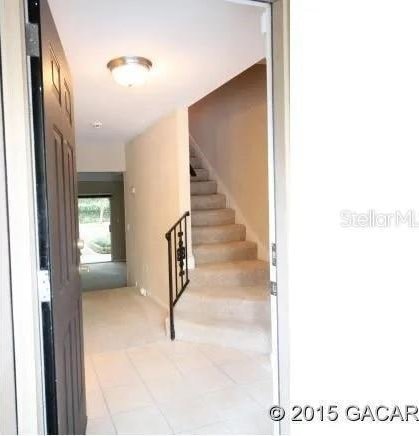 507 NW 39th Rd Unit 159, Gainesville, FL 32607 - staircase featuring tile patterned floors