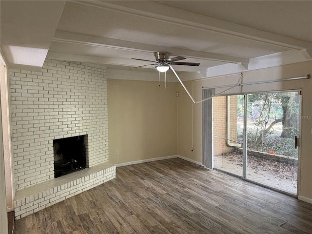 unfurnished living room with hardwood / wood-style floors, ceiling fan, a fireplace, and beamed ceiling