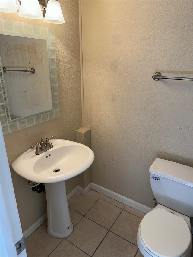 bathroom featuring toilet and tile patterned floors