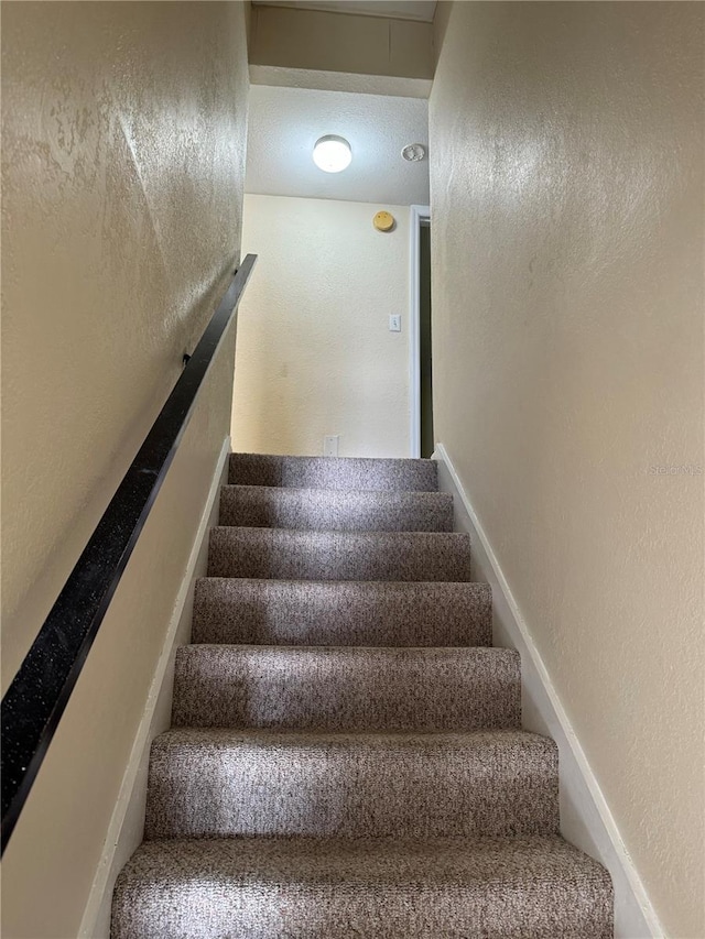 507 NW 39th Rd Unit 159, Gainesville, FL 32607 - stairway featuring a textured wall