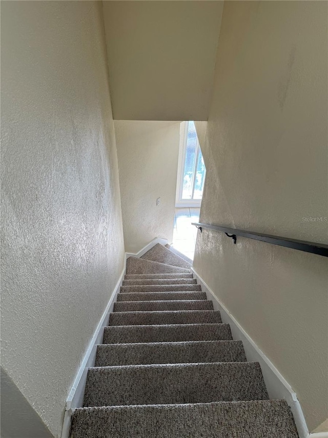 507 NW 39th Rd Unit 159, Gainesville, FL 32607 - stairs featuring a textured wall and carpet flooring
