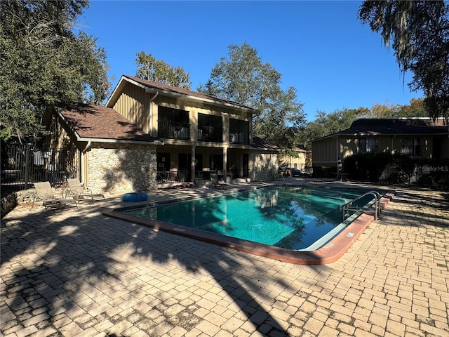 view of swimming pool with a patio