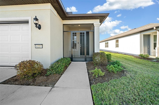 property entrance with a lawn and a garage