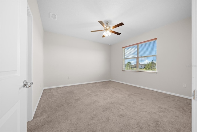 unfurnished room with light colored carpet and ceiling fan