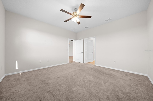 carpeted empty room featuring ceiling fan