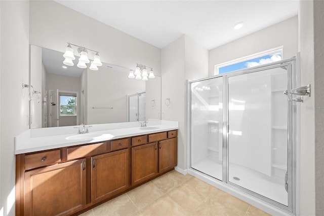 bathroom featuring tile patterned flooring, vanity, and walk in shower