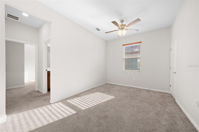 carpeted spare room with ceiling fan