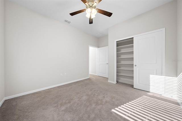 unfurnished bedroom with light carpet, a closet, and ceiling fan