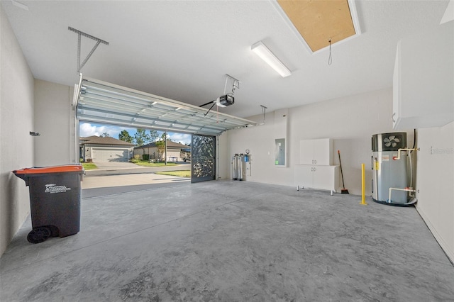 garage featuring electric panel, a garage door opener, and hybrid water heater