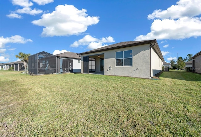 back of house with a lawn and a lanai