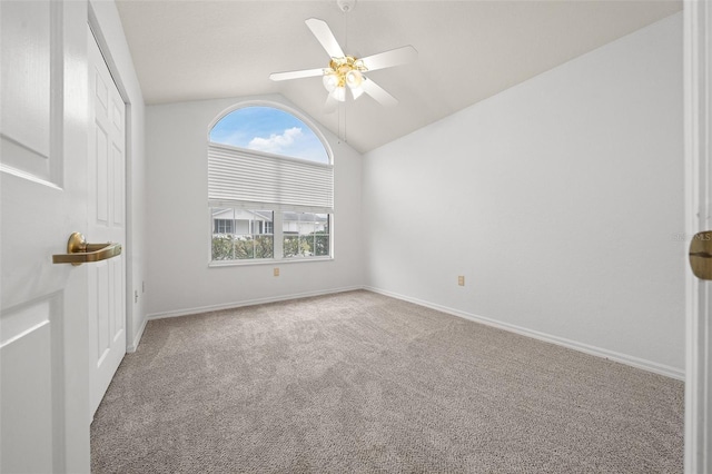 unfurnished bedroom with ceiling fan, baseboards, vaulted ceiling, and carpet flooring