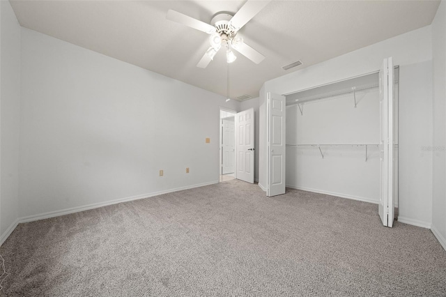 unfurnished bedroom featuring a closet, visible vents, a ceiling fan, carpet flooring, and baseboards