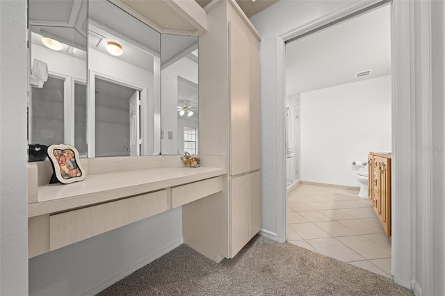 bathroom featuring tile patterned flooring, visible vents, vanity, and toilet