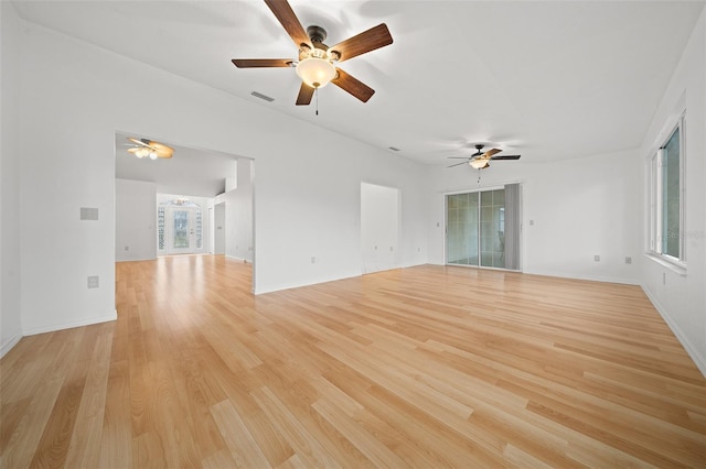 empty room with light wood-type flooring, visible vents, and baseboards